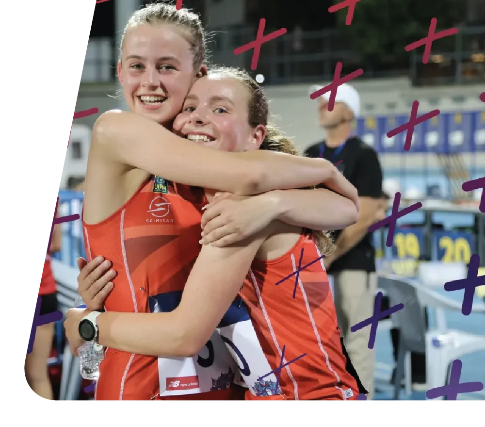 Two Pentathlon GB athletes hugging and smiling after a competition