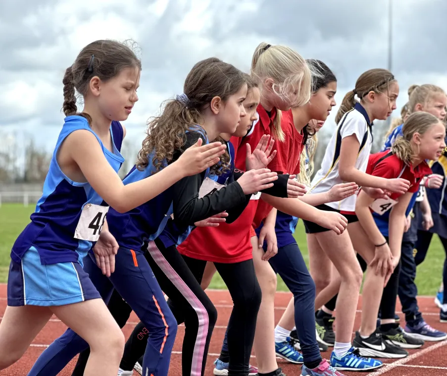 Group of young Pentathlon GB athletes at the starting line of a track race