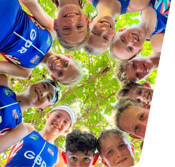 Group of young Pentathlon GB athletes smiling and looking down into the camera