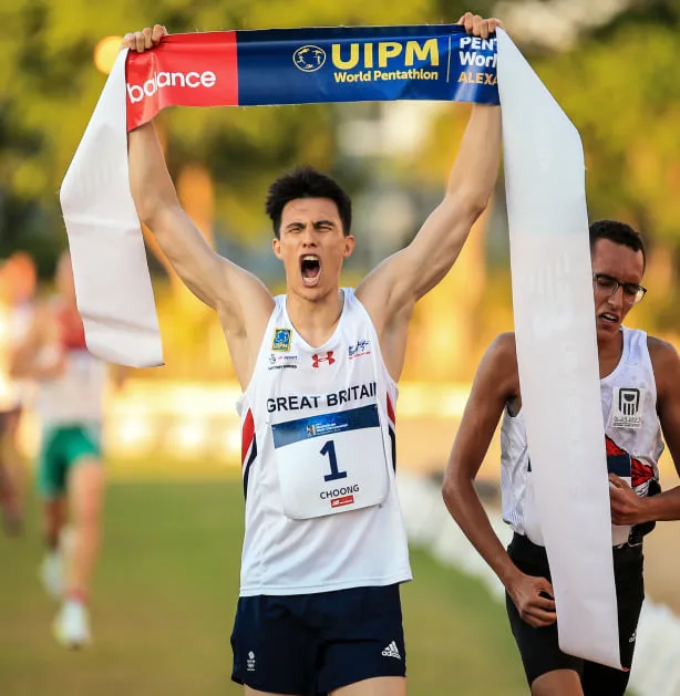 Pentathlon GB athlete Joe Choong celebrating after crossing the finish line at UIPM World Pentathlon event