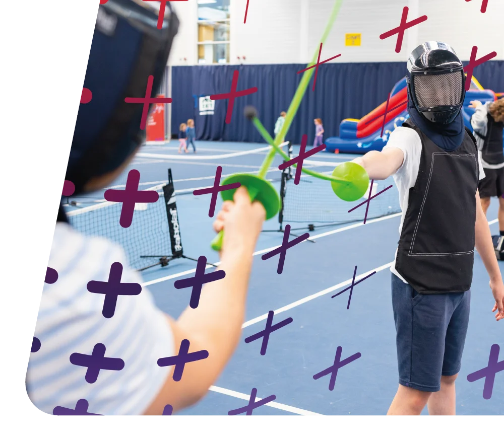 Children practicing fencing with foam swords during a Pentathlon GB event